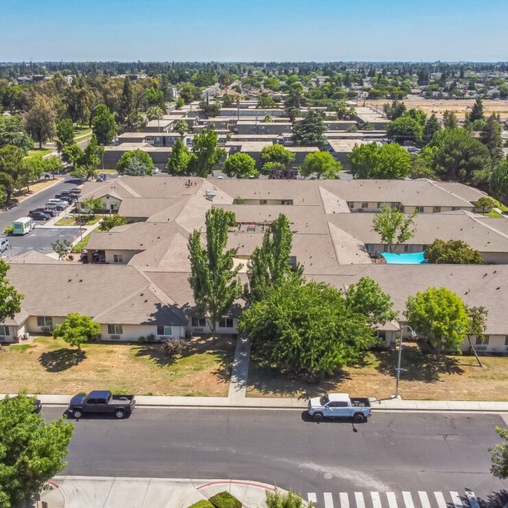 Retirement community surrounded by lush trees and quiet streets, offering a peaceful neighborhood feel.