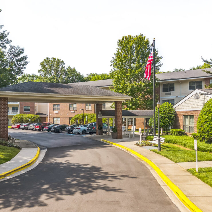 Welcoming senior living community with well-kept grounds, shaded walkways, and ample parking.