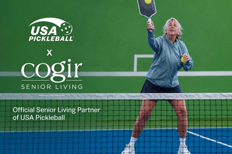 Active senior woman enjoying a game of pickleball on a vibrant outdoor court.