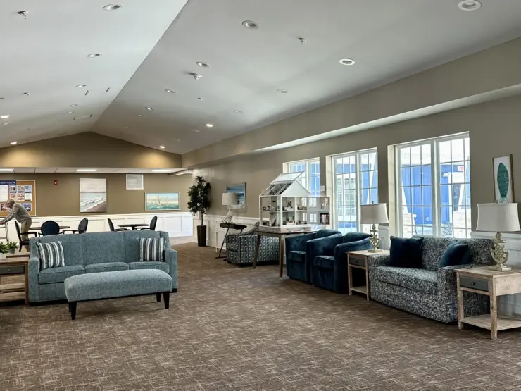 Spacious lounge with comfortable seating, natural light, and a welcoming community atmosphere.