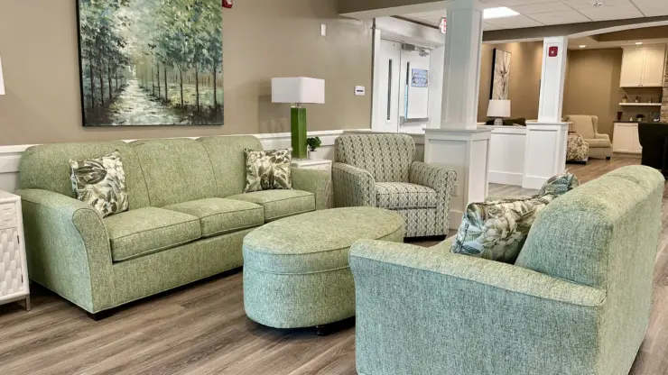 Living area with comfortable seating, soft lighting, and nature-inspired artwork promoting community and relaxation.