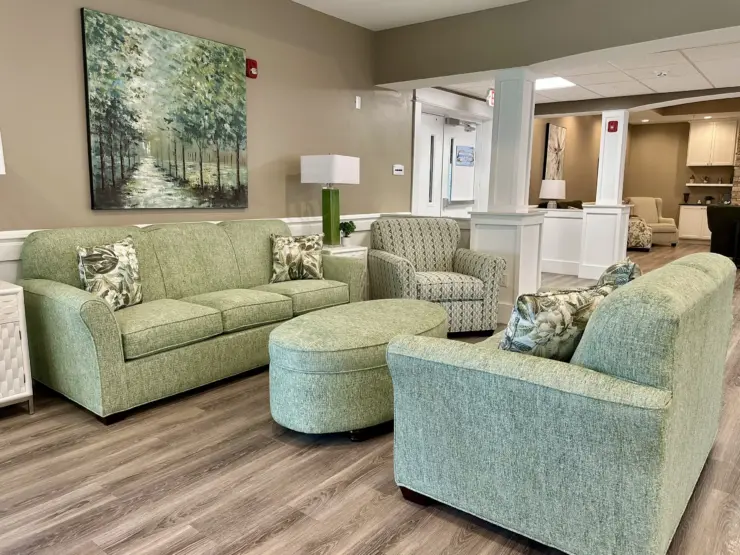 Living area with comfortable seating, soft lighting, and nature-inspired artwork promoting community and relaxation.