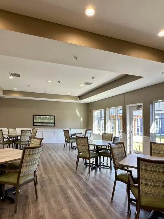 Spacious dining area with natural light, comfortable seating, and a welcoming atmosphere for residents.