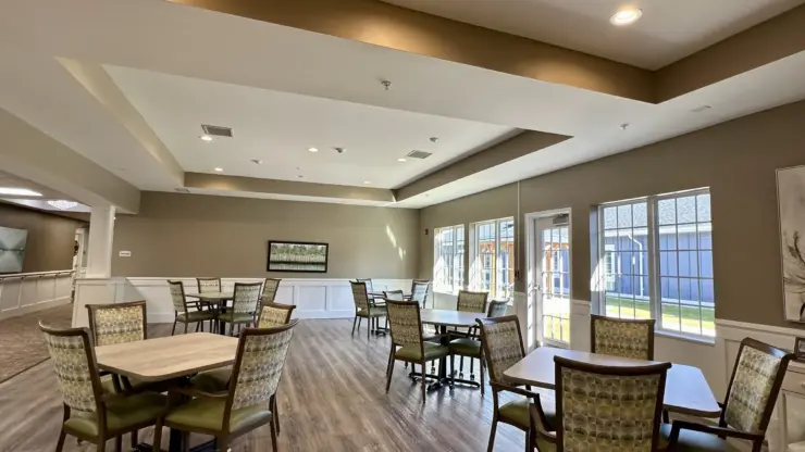 Spacious dining area with natural light, comfortable seating, and a welcoming atmosphere for residents.