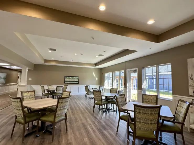 Spacious dining area with natural light, comfortable seating, and a welcoming atmosphere for residents.