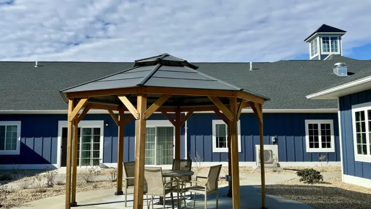 Outdoor seating area with gazebo and comfortable chairs creating a welcoming community space.