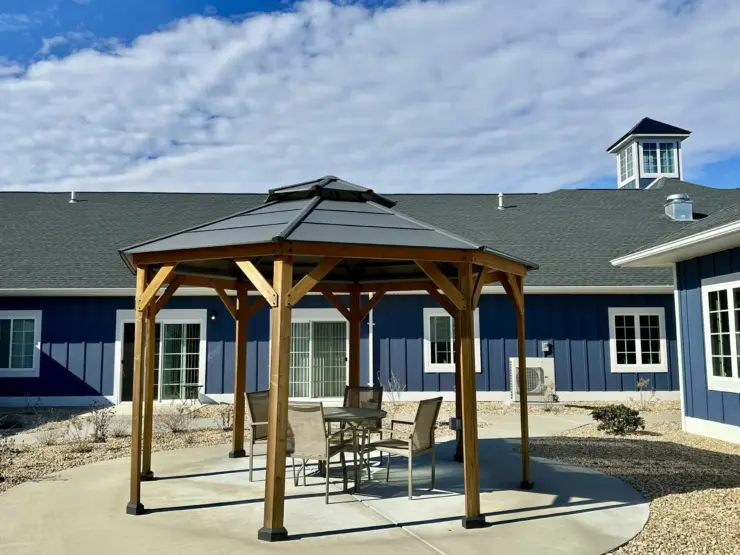 Outdoor seating area with gazebo and comfortable chairs creating a welcoming community space.
