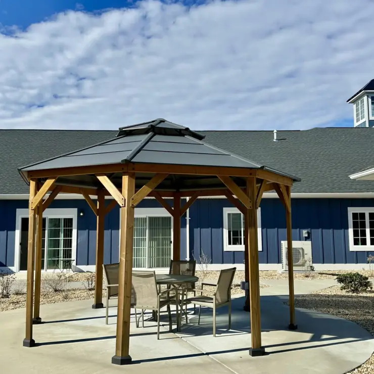 Outdoor seating area with gazebo and comfortable chairs creating a welcoming community space.