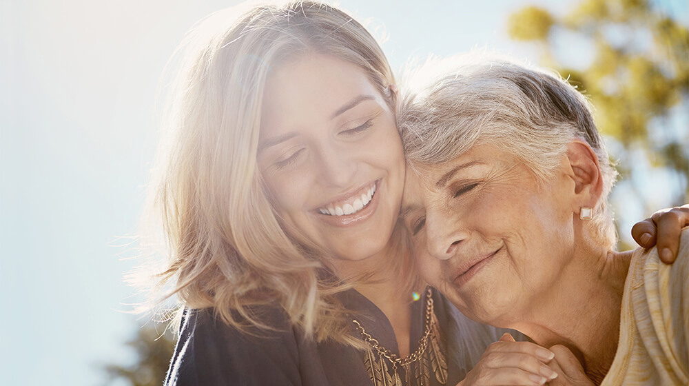 assisted living in Scottsdale AZ, Mother and daughter embrace in sun-soaked outdoor park