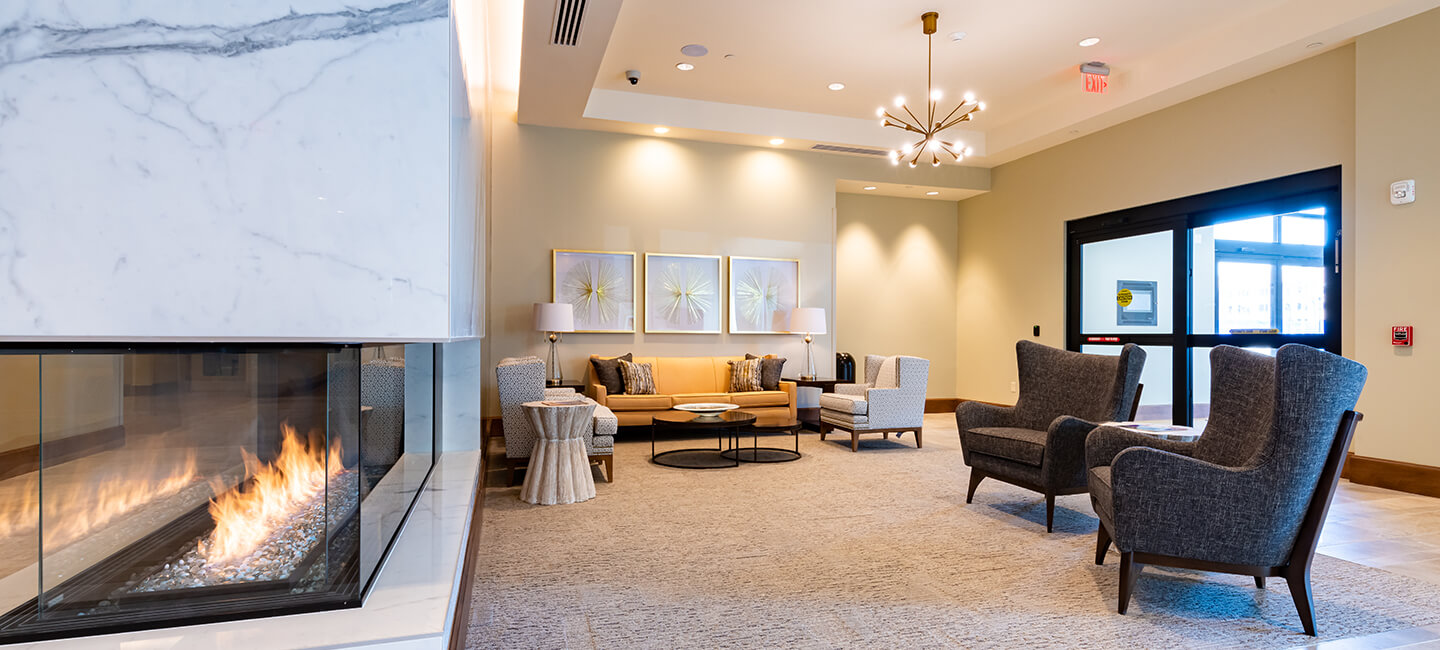 Luxury common area at Tribute at Black Hill with beautiful wall decor and glass fireplace