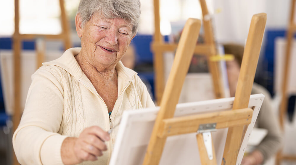 Elderly women participates in art class gleefully