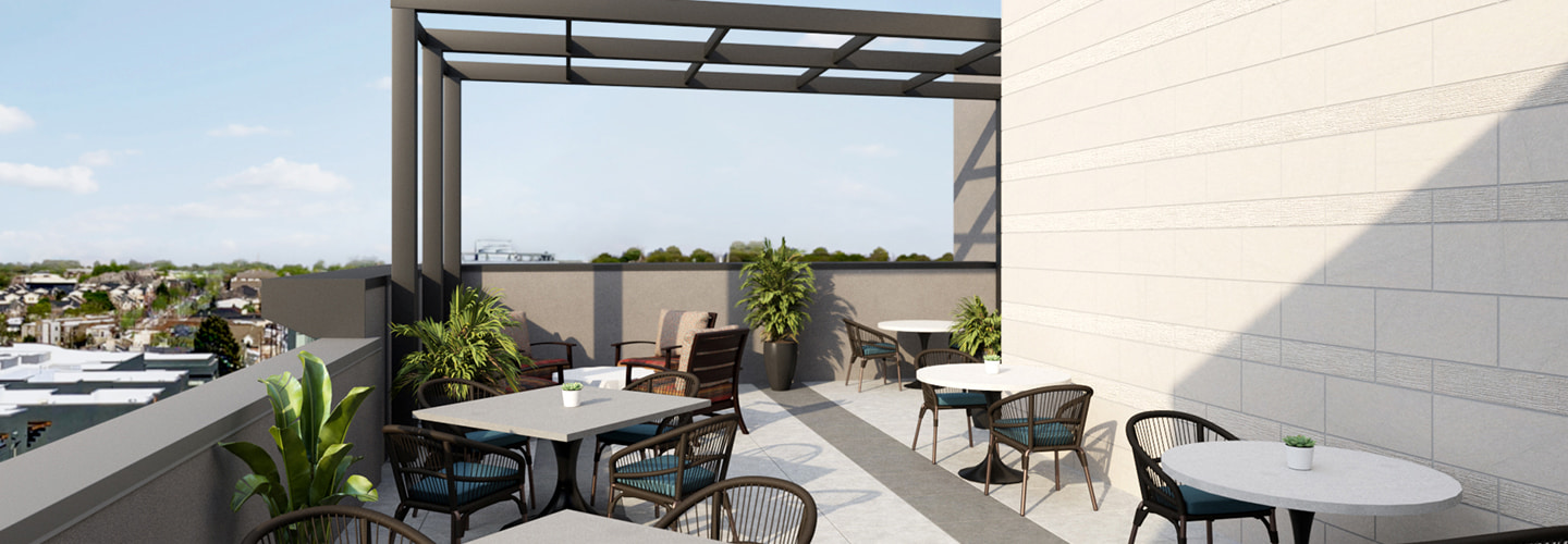 Rooftop gathering area at ACOYA Cherry Creek with tables and chairs and plants.
