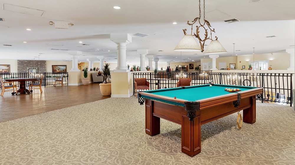 Billiards table on bright, open indoors terrace at The Montecito Senior Living